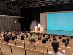 令和6年度子育て学びフィールド「幼児教育セミナー」講演会にて、あいさつ（みんなの森ぎふメディアコスモス）の様子